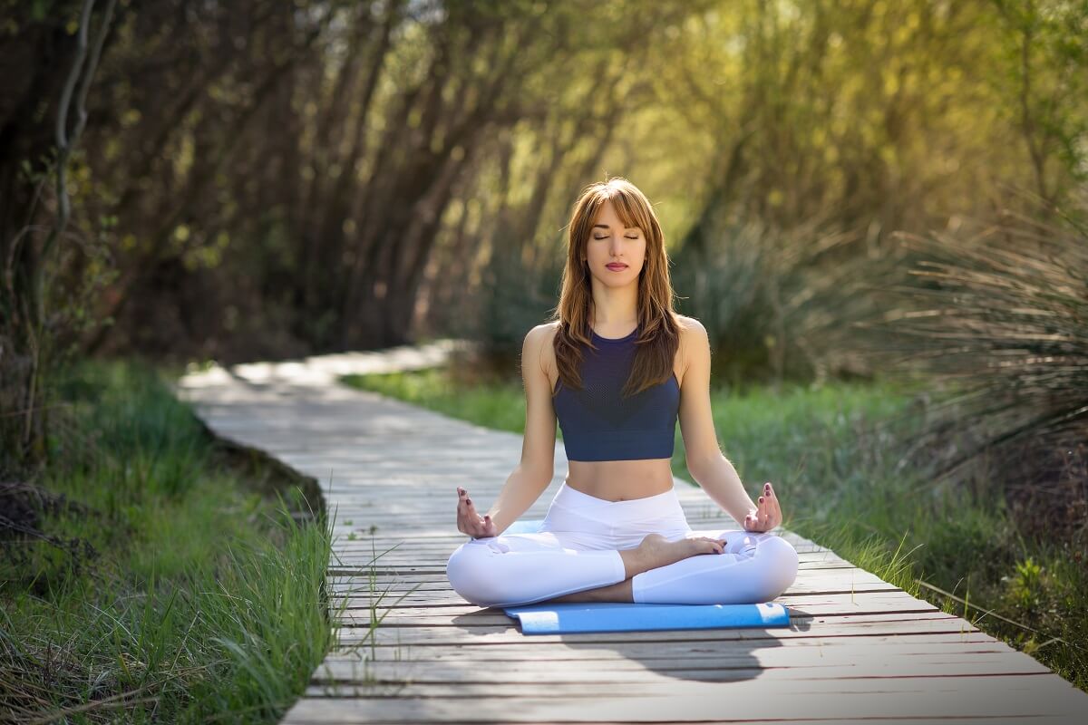 meditating-woman-on-mat-cushion